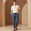 FJØRNA men's cargo trousers with drawstring, relaxed fit, featuring multiple pockets and casual style, shown on a model.