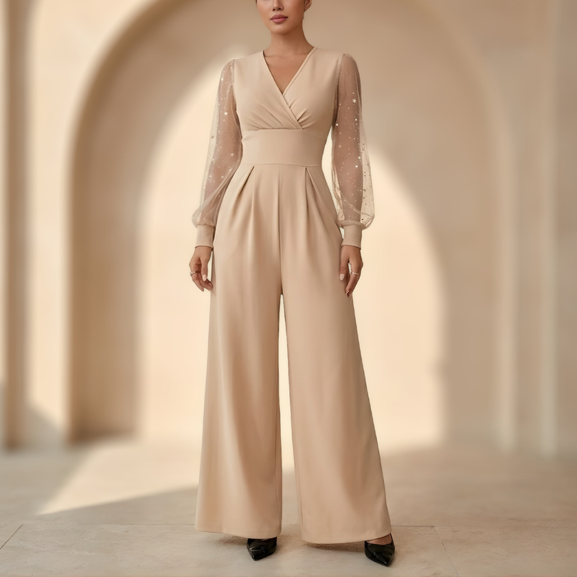 Women’s V neck mesh sleeve evening jumpsuit by FJØRNA, stylish women’s set with a V neckline and sheer mesh sleeves.