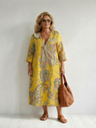 FJØRNA women's summer midi dress with paisley pattern and long sleeves, flowing and lightweight for warm weather wear.