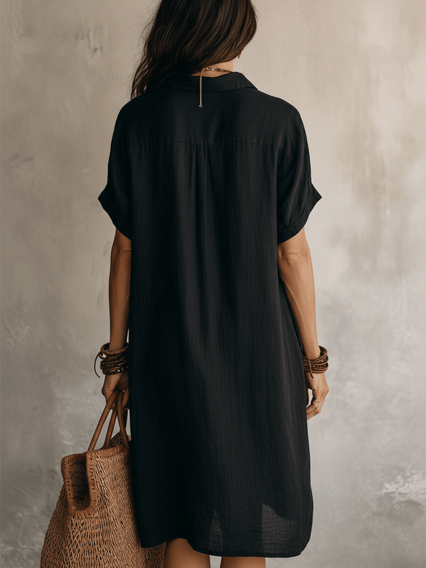 FJØRNA black linen midi dress with a relaxed boho design, featuring a simple, effortless silhouette perfect for casual or stylish wear.