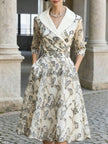 FJØRNA silver embroidered mesh midi dress with metallic leaf motifs, showcasing intricate embroidery and elegant design.