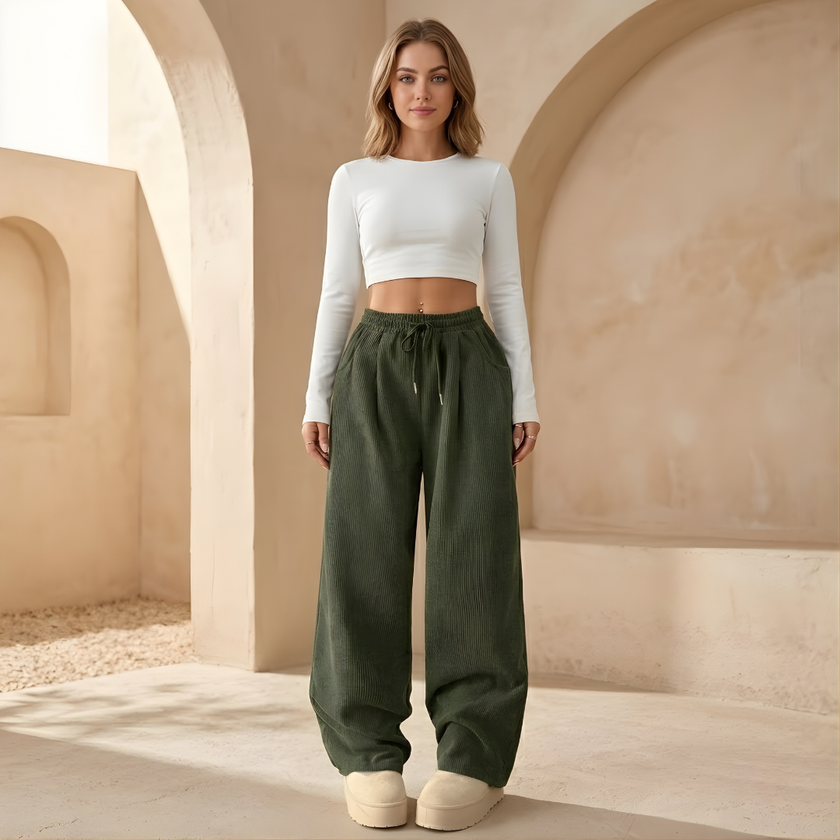 FJØRNA men's corduroy wide-leg trousers with relaxed fit, showing the textured fabric and stylish design on a neutral background.