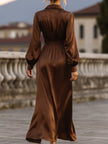 FJØRNA satin cinched waist maxi dress in mocha brown, flowing fabric with a fitted waist and elegant design.