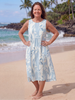 FJØRNA women's floral sleeveless summer midi dress with a flowing design and vibrant flower print on lightweight fabric.
