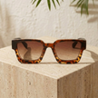Unisex vintage rectangular sunglasses by FJØRNA featuring dark tinted lenses and sleek black frames.
