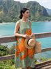 FJØRNA women's summer midi dress with sleeveless wrap design and floral print, perfect for warm-weather occasions.