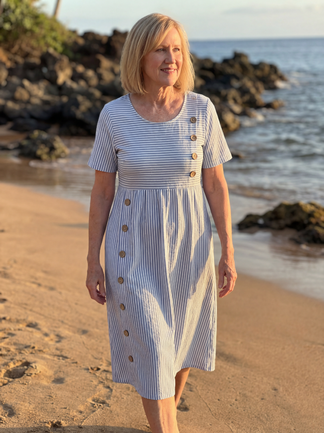 FJØRNA women’s summer midi dress with striped pattern, short sleeves, side pockets, and a relaxed fit.