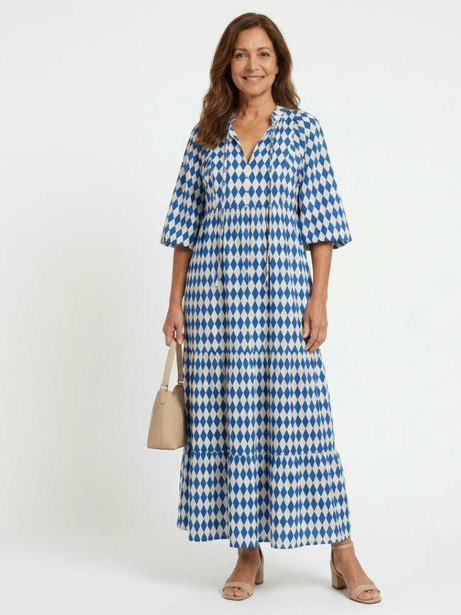 FJØRNA women's summer midi dress with a colorful print and wrap design, perfect for warm-weather occasions.