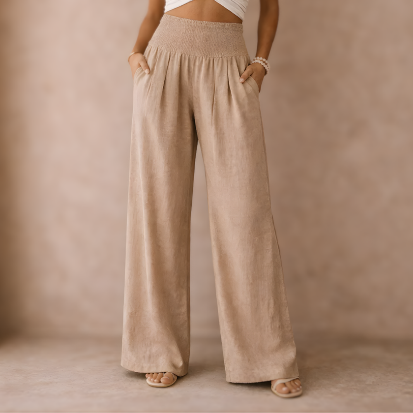 FJØRNA linen blend wide-leg women's trousers with elastic waist, relaxed fit and classic style, shown on a model.