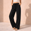 FJØRNA women's lounge trousers with drawstring waist, relaxed fit, soft fabric, suitable for casual and comfortable wear.