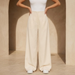 Women’s high waisted tailored wide-leg trousers by FJØRNA, featuring a sleek fit and classic design, shown in the image.