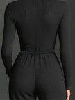 FJØRNA sparkling knit women's jumpsuit with zip front, long sleeves, wide-leg pants, and a stylish, textured design.