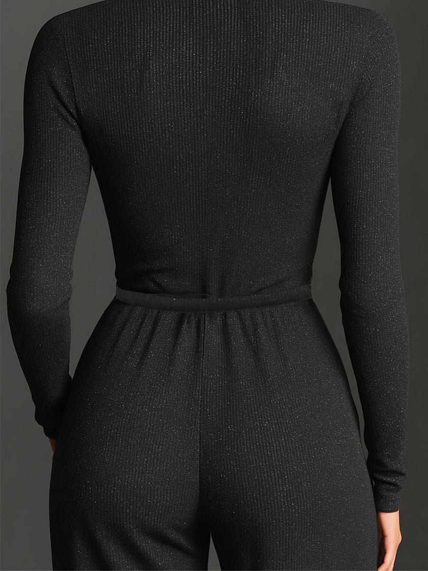 FJØRNA sparkling knit women's jumpsuit with zip front, long sleeves, wide-leg pants, and a stylish, textured design.