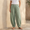 FJØRNA women's cotton linen wide-leg trousers with relaxed fit, light fabric and natural beige color, shown flat.