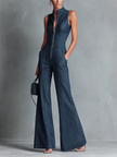 FJØRNA dark denim flared sleeveless jumpsuit for women with high neck, zipper front, and pant style design.