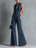 FJØRNA dark denim flared sleeveless jumpsuit for women with high neck, zipper front, and pant style design.