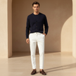 FJØRNA men's slim fit trousers, stylish men's pants with a tailored fit, shown in a neutral color on a model.