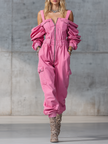 Pink denim strappy tapered long sleeve jumpsuit by FJØRNA with fitted silhouette and adjustable shoulder straps.