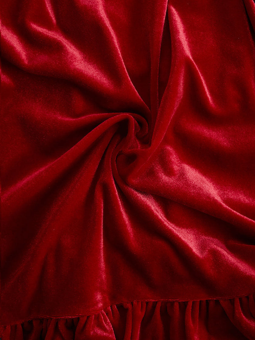 Red velvet pleated ruffled long sleeve blouse by FJØRNA, shown with detailed ruffle accents and elegant pleats on the fabric.