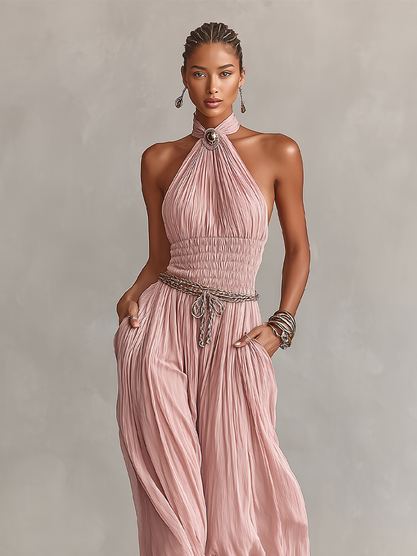 FJØRNA blush pleated jumpsuit for women with halter neck, ruched waist, and wide-leg pants, stylish and elegant.