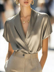 FJØRNA women's summer satin blouse with V-neck and short sleeves, stylish and lightweight for warm weather.