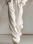 White corduroy hooded zip-front jumpsuit by FJØRNA featuring long sleeves and a casual, cozy style.