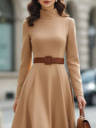 Elegant camel turtleneck belted midi dress by FJØRNA, featuring a fitted silhouette and stylish design, shown on a model.