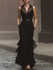 FJØRNA modern elegance sleeveless black maxi dress featuring a statement waist belt and flowing fabric.