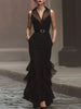 FJØRNA modern elegance sleeveless black maxi dress featuring a statement waist belt and flowing fabric.