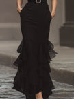 FJØRNA modern black sleeveless maxi dress with statement waist belt, elegant design and long flowing silhouette.