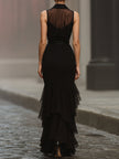 FJØRNA modern elegance sleeveless black maxi dress with statement waist belt, flowing fabric and stylish design.
