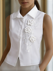 White sleeveless women's blouse with floral embroidery and 3D appliqué by FJØRNA, featuring a lightweight, elegant top design.