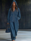 FJØRNA casual loose retro denim jumpsuit with long sleeves, hood, zipper, and front pockets, styled for a relaxed look.