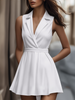 FJØRNA white pleated mini shirt dress with a collared neckline and short sleeves, styled with a fitted waist and pleated skirt.