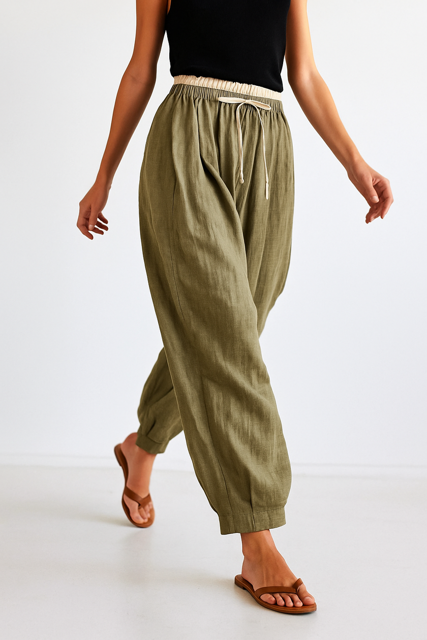FJØRNA women's linen tapered trousers, light and breathable linen pants, shown on a model with a neutral background.