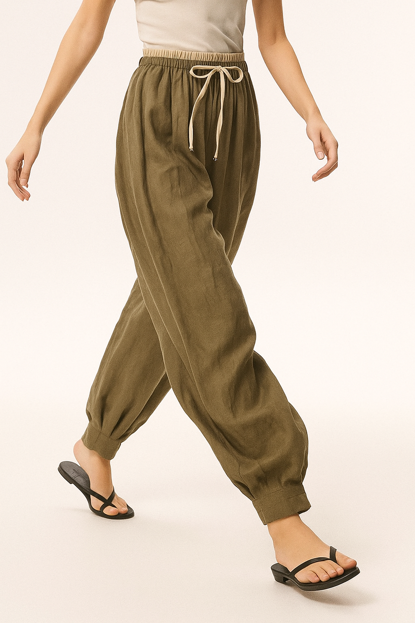 FJØRNA women's linen tapered trousers, lightweight and breathable pants with a relaxed fit, shown in natural linen fabric.