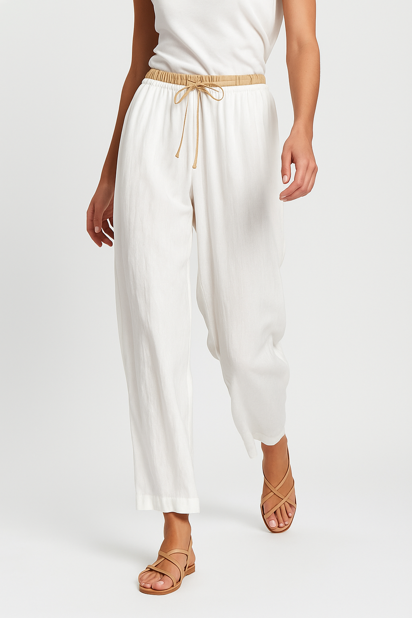 FJØRNA women's linen tapered trousers showing lightweight, breathable fabric and relaxed fit in motion.