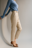 FJØRNA wool blend high waist tapered trousers for women, stylish pants with a fitted, tapered design, shown in a fashionable ensemble.