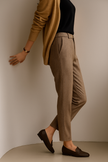 FJØRNA wool blend high waist tapered women's trousers displayed on a model, showcasing stylish tailored pants.