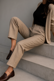 FJØRNA wool blend high waist tapered women's trousers displayed on a model, showcasing stylish and tailored pants.