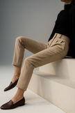 FJØRNA wool blend high waist tapered women's trousers displayed on a model, showcasing the stylish and tailored fit.