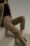 FJØRNA women’s high waist wool blend tapered trousers, relaxed fit, displayed on a model in neutral setting.
