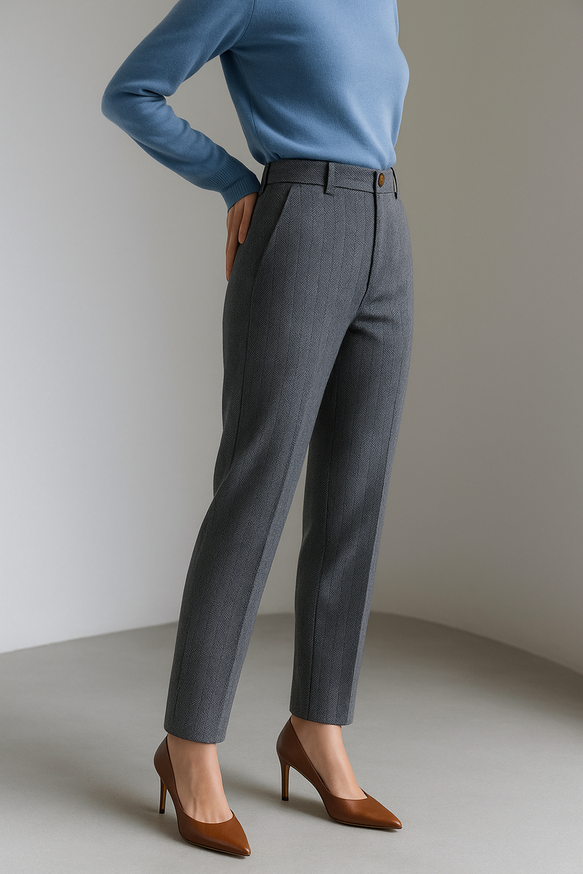 Women’s gray wool blend tapered high waist trousers by FJØRNA, shown on model with a tailored fit and clean design.