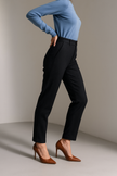 Beige wool blend tapered high waist women's pants by FJØRNA, shown on a model with a stylish fit and tailored design.