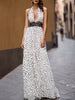 FJØRNA elegant polka dot halter maxi dress with black lace waist inlay and flowing skirt, perfect for summer occasions.