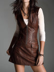 Brown eco leather zip-front mini dress for women by FJØRNA, featuring a fitted style and front zipper, displayed on a model.