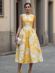 FJØRNA sleeveless floral print midi dress displayed on a hanger, showcasing vibrant flower patterns and lightweight fabric.