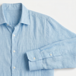 Men's FJØRNA long sleeve linen button-down shirt, lightweight and breathable, shown in a natural relaxed fit with collar and button details.
