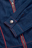 Dark blue FJØRNA denim jumpsuit with topstitching, wide-leg pants, long sleeves, and a fitted waist, styled for casual wear.