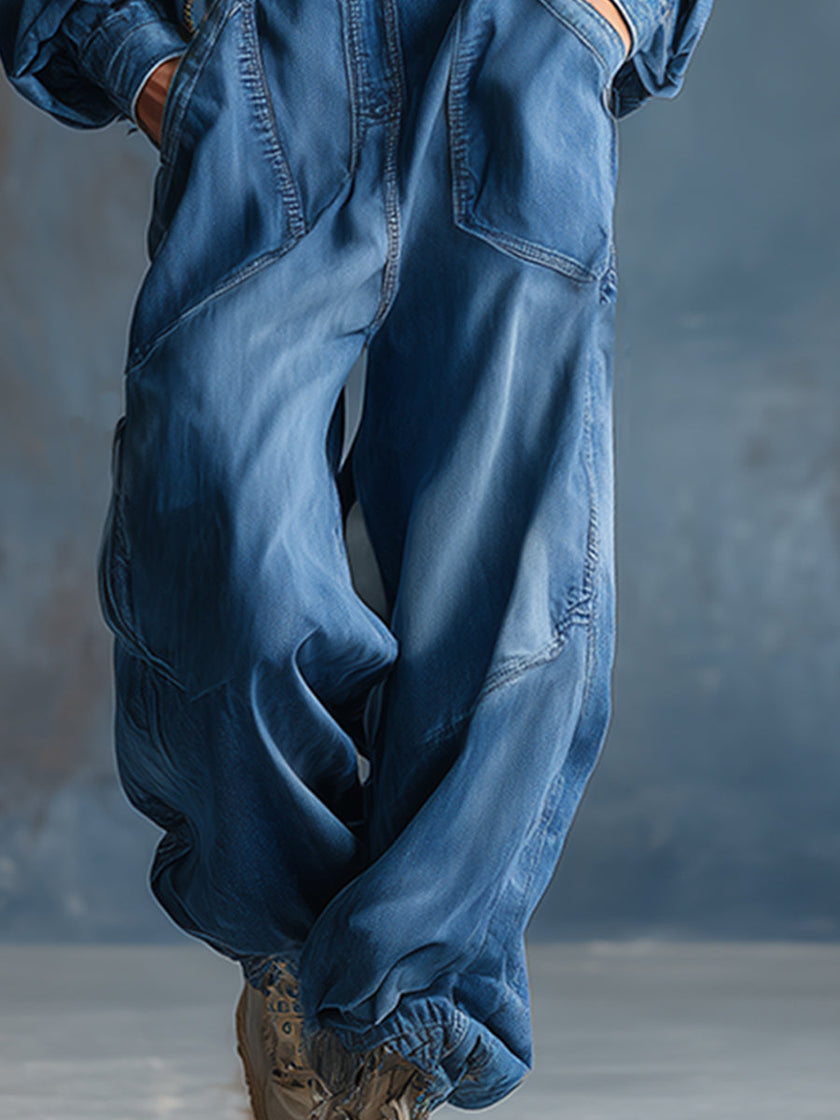 Blue denim hooded jumpsuit with button-front and long sleeves by FJØRNA, shown on a model.